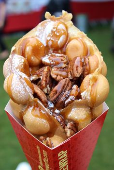 a basket filled with lots of pretzels covered in icing and pecans