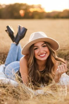 a beautiful young woman laying in the grass