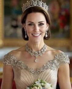 a woman wearing a tiara and holding a bouquet