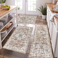 three rugs in the middle of a kitchen with fruit on the counter and plates