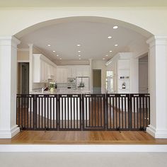 an open living room and kitchen area with white railings