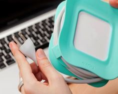 a person is plugging in to an electronic device on their lap top computer keyboard