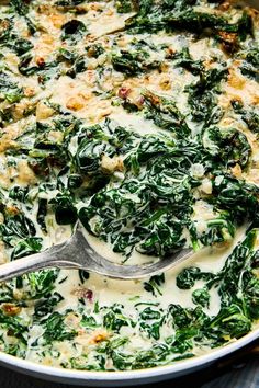 spinach and cheese casserole with a spoon in it