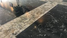 a marble floor with black and white lines on it in an office building or hotel lobby