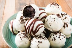 a plate filled with chocolate covered desserts on top of a wooden table