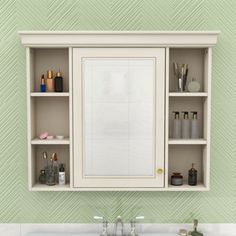 a bathroom sink sitting under a mirror next to a shelf filled with bottles and other items