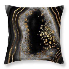 a black and gold pillow on a white wall