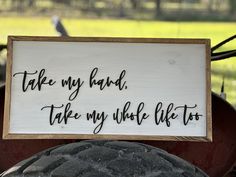 a sign that says take my hand, take my whole life too on the back of a tractor