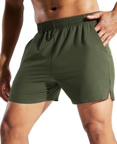 a man in green shorts with his hand on his hip and the bottom half of his body