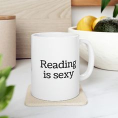 Indulge in the irresistible allure of reading with our 11 oz. ceramic coffee mug featuring the captivating phrase "Reading Is Sexy." This mug celebrates the beauty and seduction of the written word, igniting a passionate connection with literature and knowledge. Huge Coffee Mug, Book Mug, Book Mug Design, Book Worm Coffee Mug, Ironic Coffee Mugs, Best Coffee Mugs, Gifts For Bookworms, Best Coffee, Hot Drink