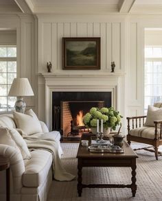 a living room filled with furniture and a fire place in front of a painting on the wall