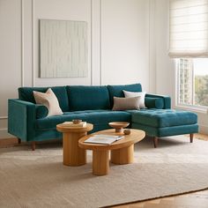 a living room scene with focus on the couch and coffee table in front of the window