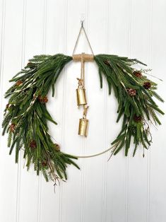 ○ This trendy modern Norfolk pine wreath is perfect for your Christmas decorations, winter door decor, or a New Years wreath  ○ What I like about this winter hoop wreath is that it is a bold, modern statement piece.  The artificial pine, and pine cones are realistic, and high quality.   ○ This pine winter decor would make a stunning statement as a Christmas wreath for the front door, or would also look great inside as a part of your interior decorations. ○ Winter pine wreaths make great gifts for the holidays, an anniversary, or a birthday.  HOW IT'S MADE ○ Created with high quality, real-touch Norfolk pine, and pinecones on a 14inch diameter gold hoop.  **You can choose if you want to add the gold accents, or leave it just plain pine.** ○ Brown rope ties the arrangement together in a very Modern Traditional Christmas, New Years Wreath, Wreath With Bells, Modern Christmas Wreath, Pine Wreaths, Winter Door Decor, Winter Wreath For Front Door, Christmas Wreath Designs, Winter Door Decorations