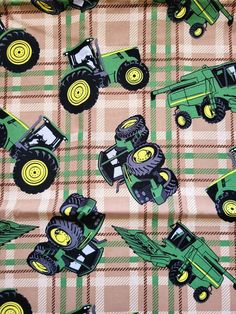 a green and yellow plaid fabric with tractors on the front, in various sizes and colors