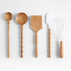 five wooden utensils lined up in a row