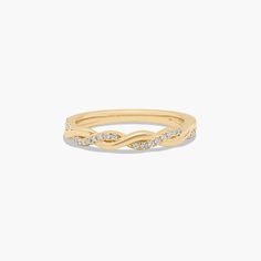 a yellow gold ring with diamonds on the sides and a thin band in the middle