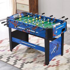 a foosball table sitting on top of a rug