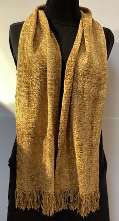 "Luxurious scarves handwoven in rich golds. The 100% rayon chenille fiber content provides rich colors, soft texture, and beautiful drape. Plus it is non-irritating to the skin. Both functional and fashionable. Hand wash, hang to dry, and steam iron. The gold scarf measures 9\" wide by 60\" long excluding fringe and the gold and yellow stripe is 7\" wide by 60\" long. The ends are secured with a tight zigzag machine stitch. I hand wash, dry, and iron all my scarves prior to shipping. Choose your Elegant Gold Scarf One Size, Gold Shawl For Fall, Festive Gold Shawl Scarf, Gold Scarf, Handwoven Scarf, Steam Iron, Beautiful Drapes, Yellow Stripes, Rich Colors