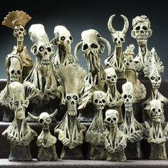 there are many skulls and skeletons on the steps in front of each other, all with different facial expressions