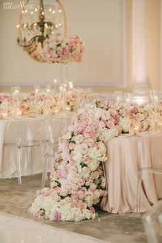 the table is set with flowers and candles for an elegant wedding reception at the four seasons hotel