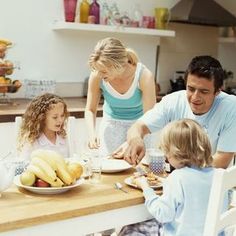 a family sitting around a table eating food