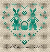 a cross stitch pattern with two people in the shape of a heart and stars on it