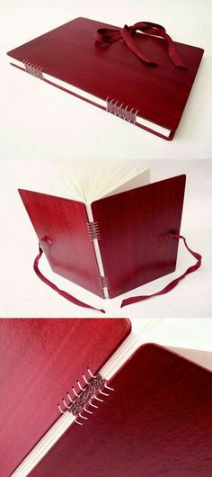 a red book is open and sitting on a white surface with the pages folded down