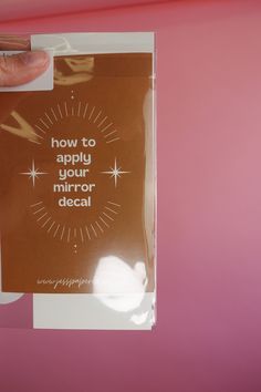 someone is holding up a card that says, how to apply your mirror decal