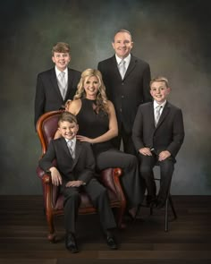 a family posing for a photo in formal attire