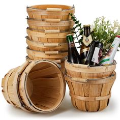 several wooden buckets stacked on top of each other with beer bottles in the middle