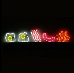 a neon sign that is lit up in the dark