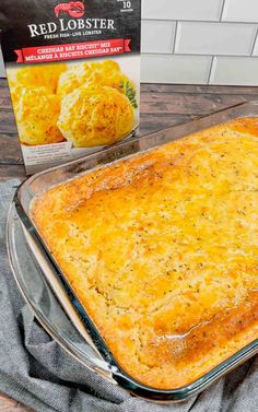 a casserole in a glass dish next to a packet of red lobster tater tots