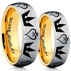 two gold and silver wedding bands with black lettering on them, one has an arrow in the