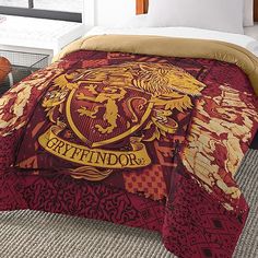 a bed with a harry potter comforter and pillows