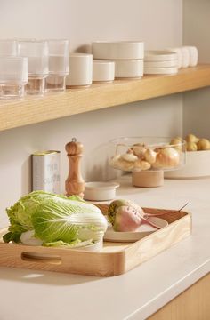 lettuce and other vegetables are on a cutting board in the kitchen countertop