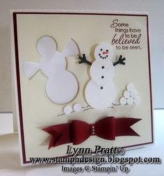 a white card with a red bow and snowman on it