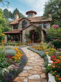 a stone house surrounded by colorful flowers and greenery in the foreground is a path leading to it