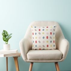 a chair with a pillow on it in front of a blue wall and a potted plant