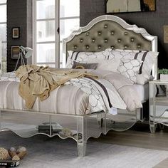 a bedroom with a bed, dresser and mirror table in it's center area