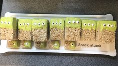 rice krispy treats with green eyes and googly eyes are arranged on a white plate