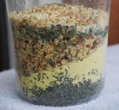 a jar filled with lots of food sitting on top of a white cloth covered table