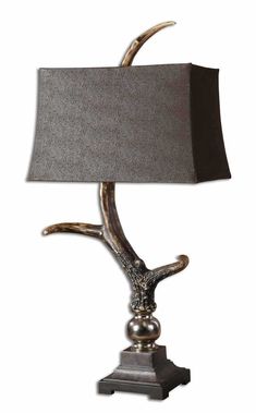 a table lamp with an animal head on it's base and a gray shade