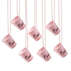 four pink coffee cups hanging from chains