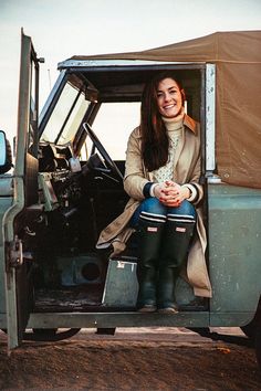 a woman sitting in the back of a truck