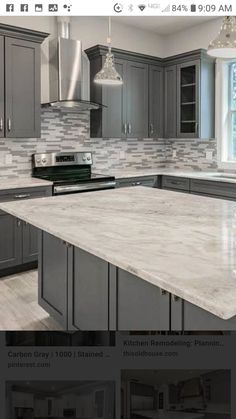 an image of a kitchen with gray cabinets and marble counter tops on the website page