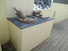 an old mortar and mortar bowl sitting on top of a counter