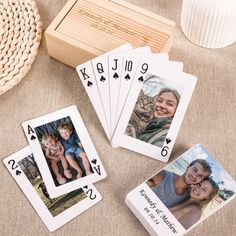 four playing cards with photos on them sitting next to a basket and some other items