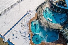 an aerial view of a swimming pool in the snow