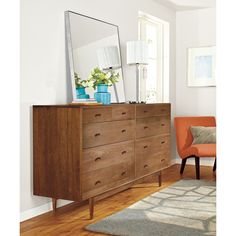 a wooden dresser with a mirror on top of it