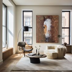 a living room filled with furniture and large windows next to a painting on the wall